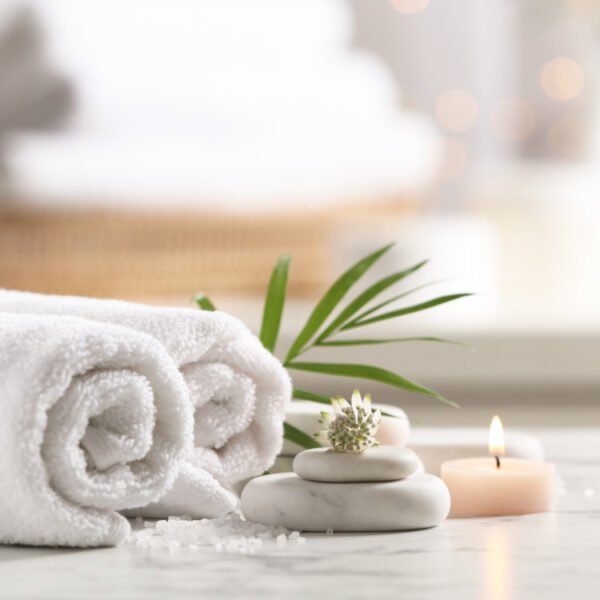 Beautiful composition with spa stones on white marble table